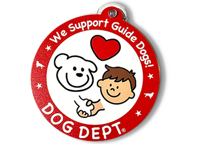 丸いステッカーの中に円周上にウイーサポートガイドドッグス！とDOGDEPTの文字とロゴがあり、内側には犬と人の顔と犬と人が握手する可愛いイラストが描かれています。